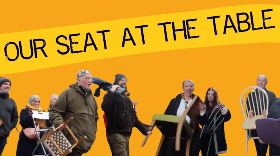 Image of Photograph of eight people each carrying a different type of chair against a solid orange background with text 