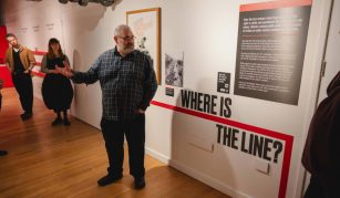 Image of Colour photograph of a person leading a tour in a gallery.