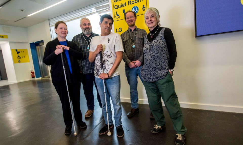 A group of people in a museum foyer.