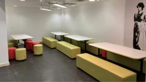 Picnic tables with stools and bench seating.