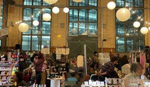 Image of Market stalls at PHM with shoppers and stall holders.