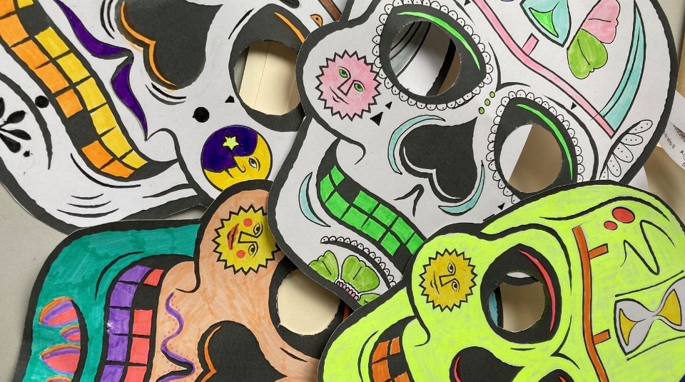 Image of Flat lay of colourful paper skeleton masks.