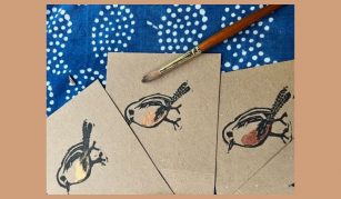 Image of Colour photograph of cards featuring a lino print robin design.