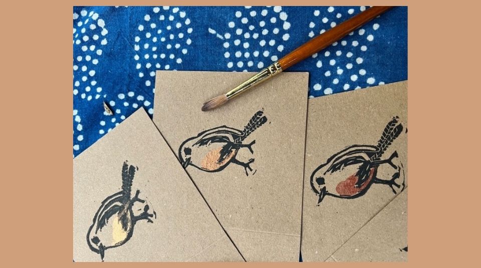 Image of Colour photograph of cards featuring a lino print robin design.