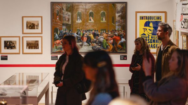 Image of Colour photograph of a group of people on a tour in a gallery.
