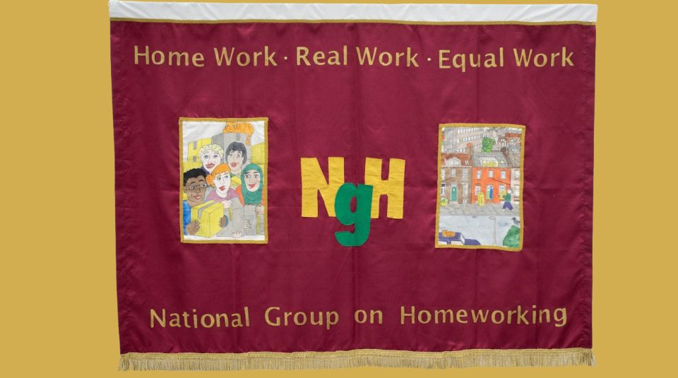 Image of A dark read banner with text including: 'Home Work, Real Work, Equal Work' and two illustrated patches; one with a group of people holding boxes, and one with a person delivering boxes to a house.